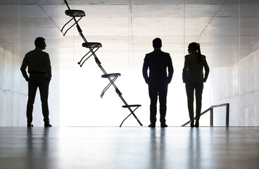 Business people standing next to office chair installation art