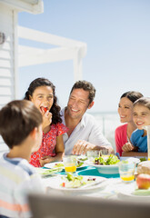 Family eating lunch on sunny patio