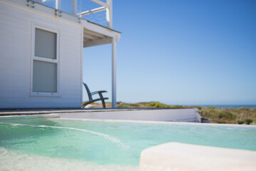 Fototapeta na wymiar Infinity pool and beach house overlooking ocean