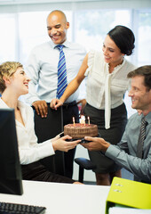 Business people celebrating birthday in office