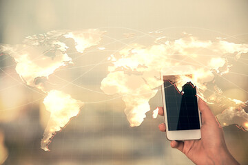 Double exposure of business theme sketch hologram and woman holding and using a mobile device.