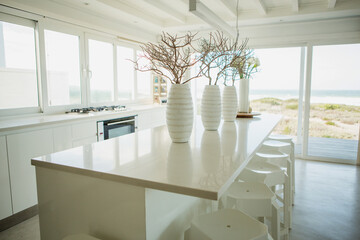 Vases on counter in kitchen with ocean view