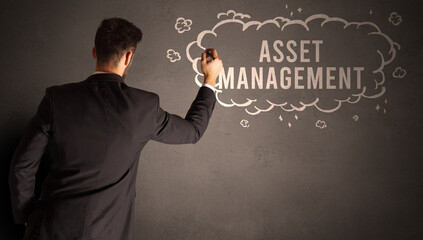 businessman drawing a cloud with ASSET MANAGEMENT inscription inside, modern business concept