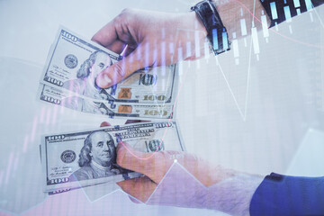 Multi exposure of financial graph drawing hologram and USA dollars bills and man hands. Analysis concept.