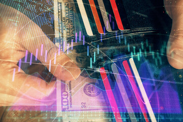 Multi exposure of forex graph drawing hologram and USA dollars bills and man hands. Technical Analysis concept.