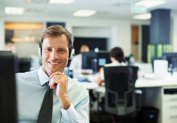 Businessman wearing headset in office