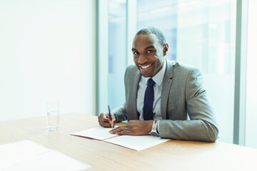 Fototapeta na wymiar Businessman smiling at conference table