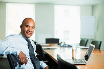 Businessman smiling at conference table