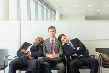 Businessmen sleeping in waiting area