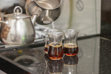 Turkish tea with authentic glass cup and silver tea kettle. 