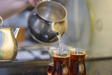 Turkish tea with authentic glass cup and silver tea kettle. 