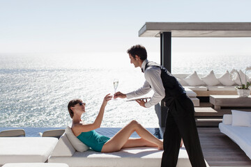 Waiter serving woman drinks outdoors