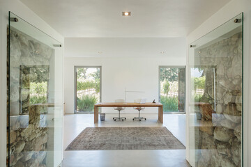 Rocks behind glass in wall of modern home office