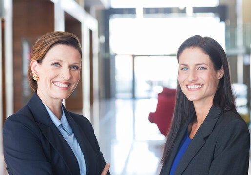 Businesswomen smiling in lobby