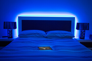 Digital tablet on glowing bed