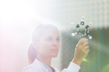 Scientist examining molecule model