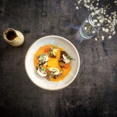 Squash soup on the black table. 