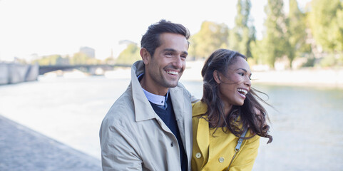 Couple walking along Seine River, Paris, France