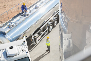 Workers around stainless steel milk tanker