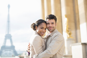 Couple hugging near Eiffel Tower, Paris, France