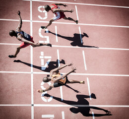 Runners crossing finish line on track © Tom Merton/KOTO