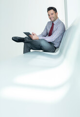 Businessman using digital tablet in lobby