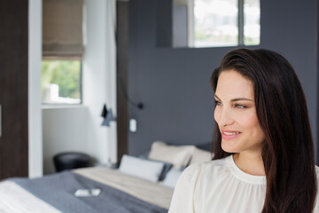 Smiling woman in bedroom