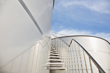 Stairs winding along stainless steel silage storage tower