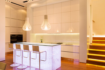 Bar stools and lighting in modern kitchen