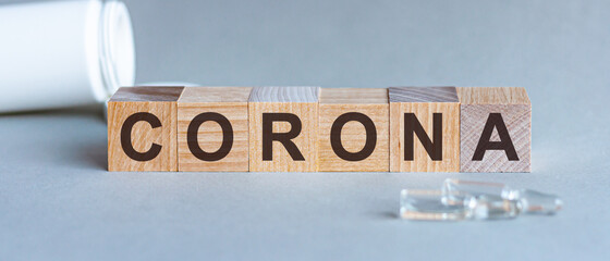 Corona Virus infection concept. Letter of wooden blocks. Grey background.