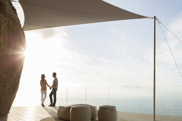 Couple standing on modern balcony