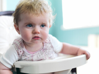 Girl sitting in high chair