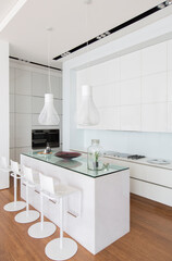 Bar stools at counter in modern kitchen