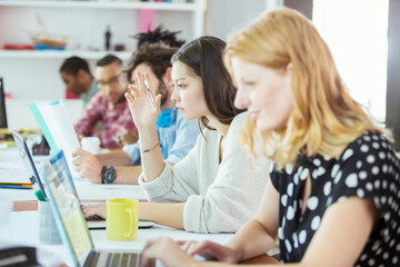 People working at conference table in office