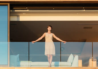 Woman standing on luxury balcony