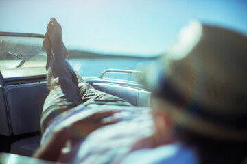 Man relaxing on boat near beach