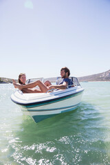Couple sitting together in boat on water 