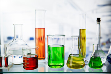 Beakers of various solutions on shelf in lab