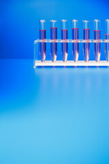 Rack of test tubes with solution on blue counter