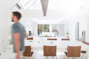 Blurred view of man walking in modern dining room