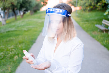 Business female in face shield isolation transparent mask on urban background. Health protection...