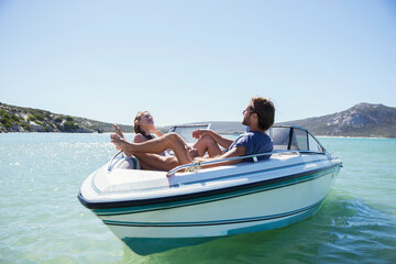 Couple sitting together in boat on water 