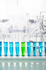 Rack of test tubes with solution on counter in lab