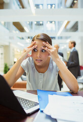 Stressed businesswoman working in office building