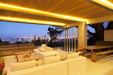 Modern living room overlooking illuminated cityscape at night