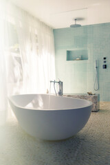 Water pouring into bathtub in modern bathroom