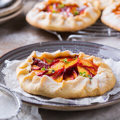 Homemade seasonal summer fruit galette, tart, pie with nectarines, peaches