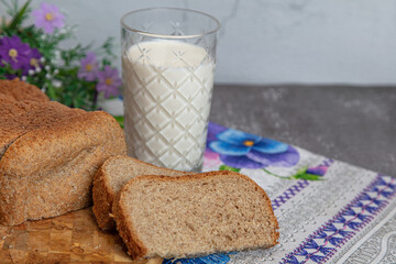 Black sliced bread, homemade cakes. A glass of milk
black close-up