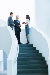 Obraz premium Business people talking on stairs of office building