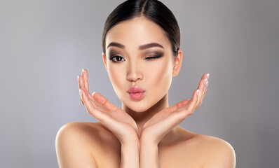 Beautiful young asian woman with Clean Fresh Skin on face . Oriental girl Facial  treatment   . Cosmetology , beauty  and spa . Skin care. Chinese and Japanese cosmetics